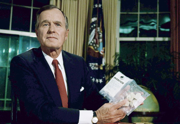 President George Bush holds a bag of crack cocaine in the Oval Office of the White House on Sept. 5, 1989, after delivering his first nationally televised speech.