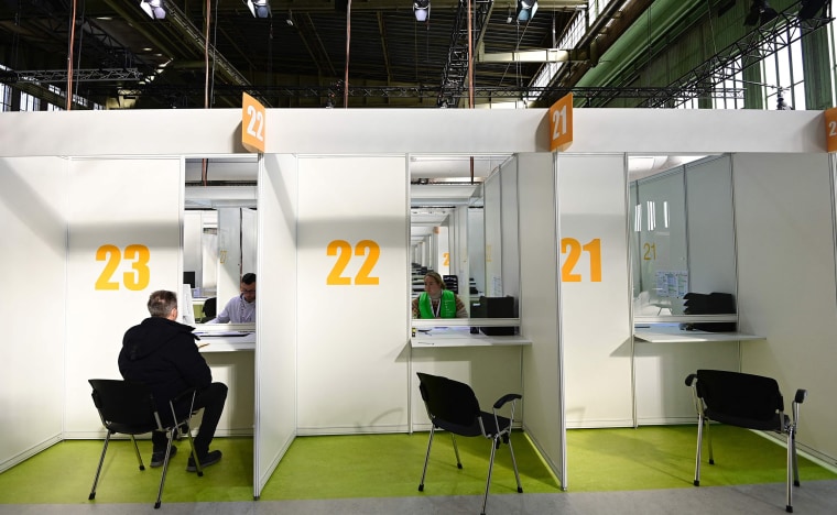 Image: German police officer Dirk Moeller registers to get an AstraZeneca vaccination against Covid-19 at a new vaccination center at the former Tempelhof airport in Berlin