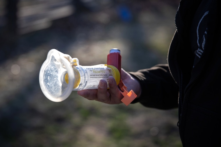 Image: Pedro Rios holds his son Felix's "Flow-Vu" inhaler, used for asthma, outside the family's home in Weed, Calif., on Feb. 23, 2021.