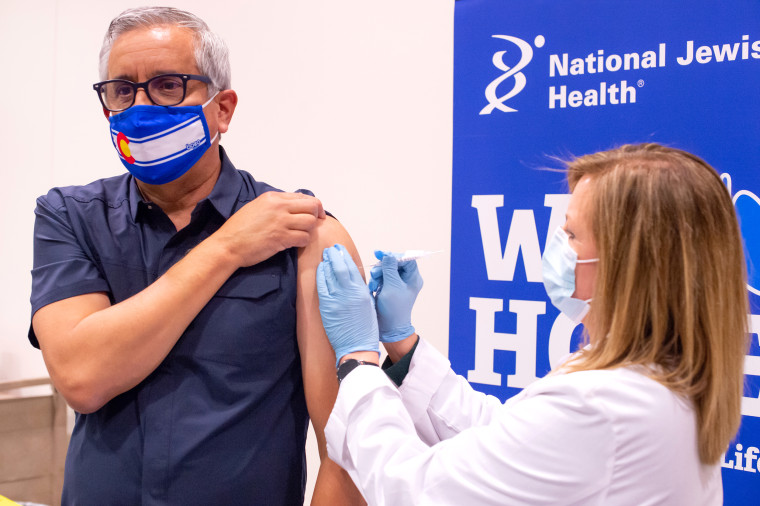 Image: Dr John Torres receives a Covid-19 vaccination shot