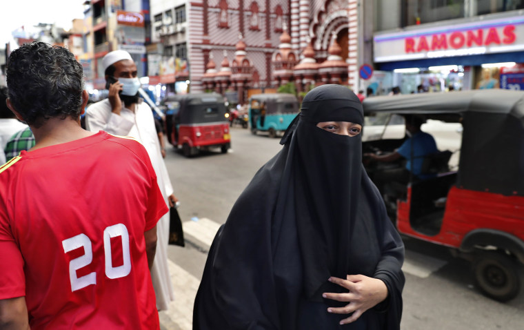 Image: A burqa-clad Muslim woman walks in Colombo, Sri Lanka, on March 13, 2021.