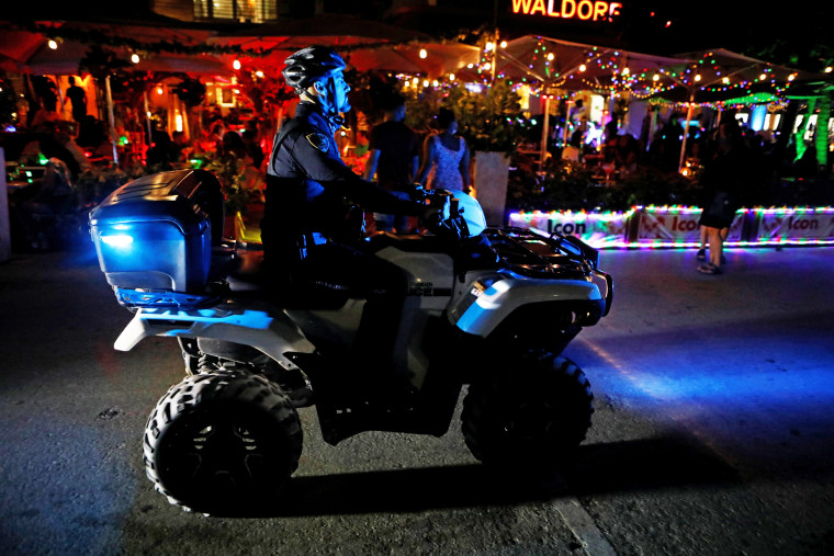 A police officer patrols Ocean Drive during spring break festivities in Miami Beach, Fla., on March 5, 2021.