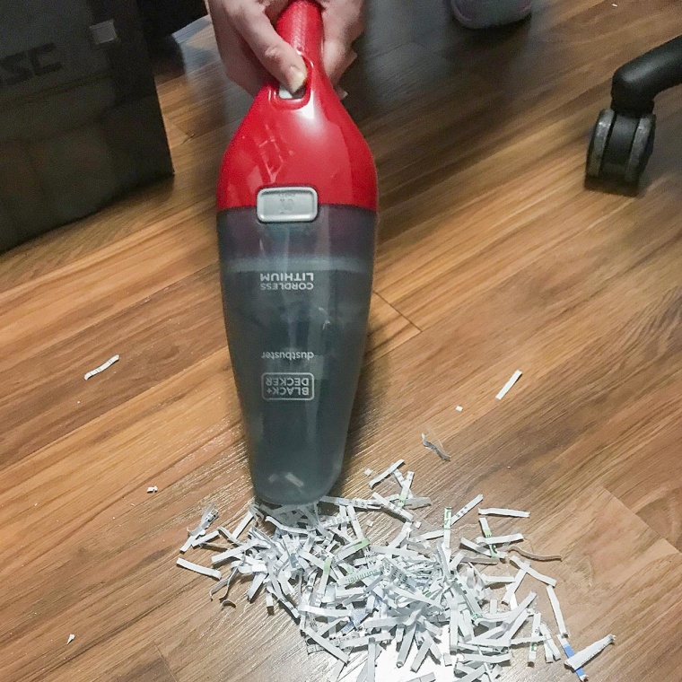 Chrissy Callahan using her BLACK+DECKER Dustbuster Hand Vacuum from Walmart Plus