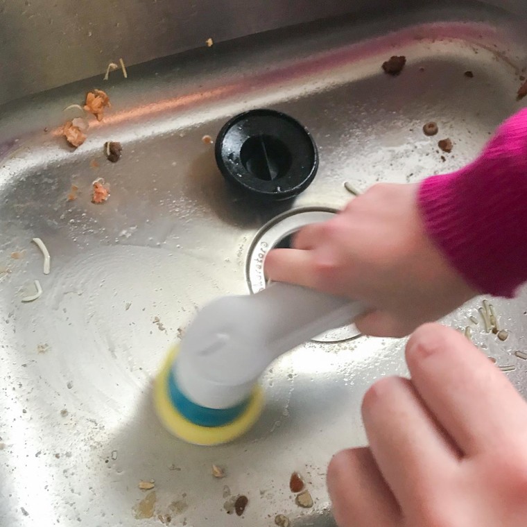 Chrissy Callahan using a BLACK+DECKER Grimebuster Pro-Rechargeable Power Scrubber