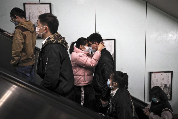Couple hugs on escalator in Beijing