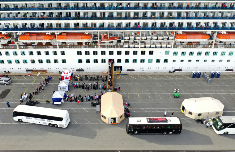 Image: Passengers disembark from the Princess Cruises Grand Princess as it sits docked in the Port of Oakland