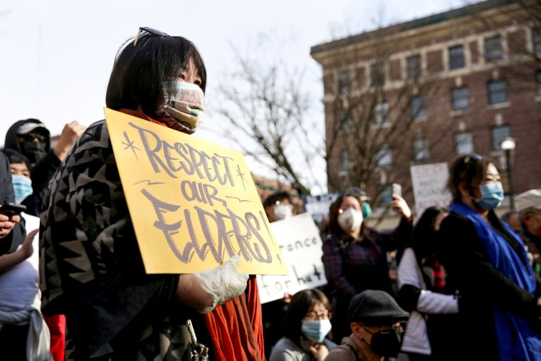 Image: A woman holds a sign that reads "Respect Our Elders" during the "We Are Not Silent" rally against anti-Asian hate in response to recent anti-Asian crime in the Chinatown-International District of Seattle on March 13, 2021.