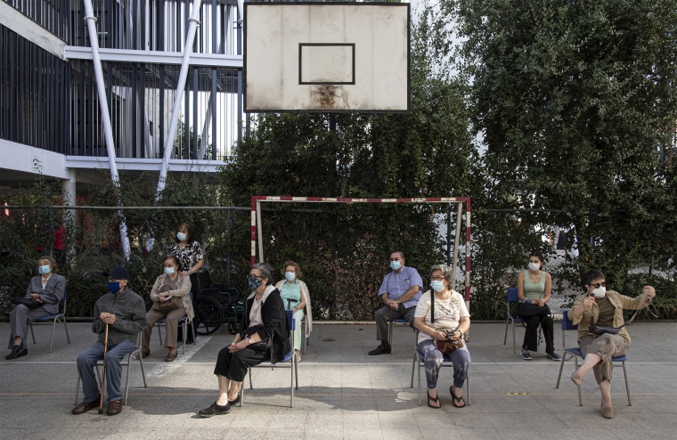 Image: People wait to get their second doses of China's Sinovac vaccine in Santiago, Chile, last month.