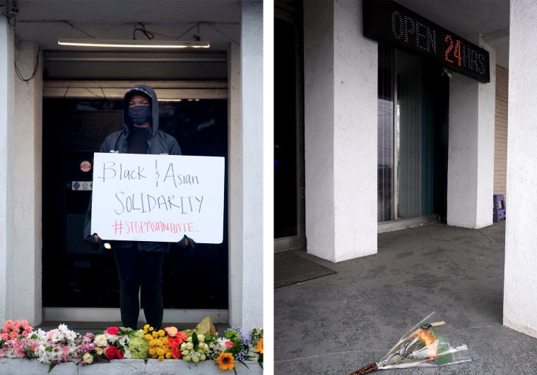 Image: "This is what we do, we protect the people," said Kat Bagger, left, outside of Gold Spa in Atlanta on Wednesday. Mourners left flowers, signs and candles after Gold Spa and two other Atlanta-area massage parlors were targeted by a shooter that left