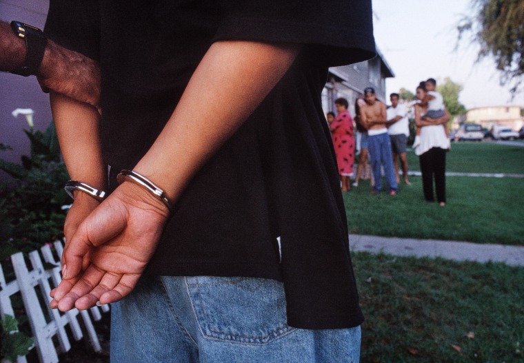 A murder suspect is arrested at the Mar Vista Gardens housing project as his family watches.