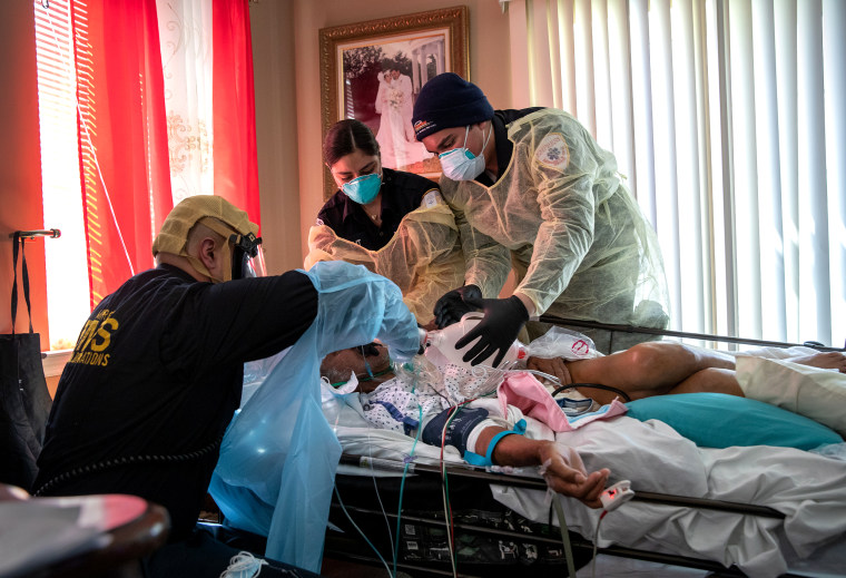 Medics intubate a gravely ill patient with Covid-19 symptoms at his home on April 6, 2020 in Yonkers, N.Y.