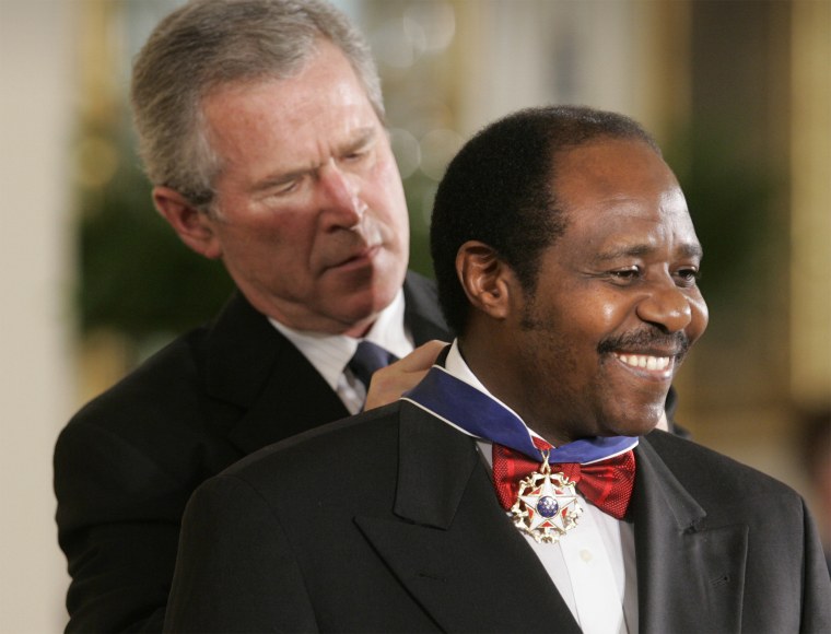 Image: President George W. Bush awards Paul Rusesabagina, who sheltered people at a hotel he managed during the 1994 Rwandan genocide, the Presidential Medal of Freedom Award in the East Room of the White House