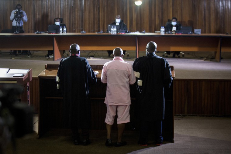 Image: Paul Rusesabagina, who inspired the film "Hotel Rwanda" and is credited with saving more than 1,000 people by sheltering them at the hotel he managed during the genocide, stands before the judge as he attends a court hearing in Kigali, Rwanda