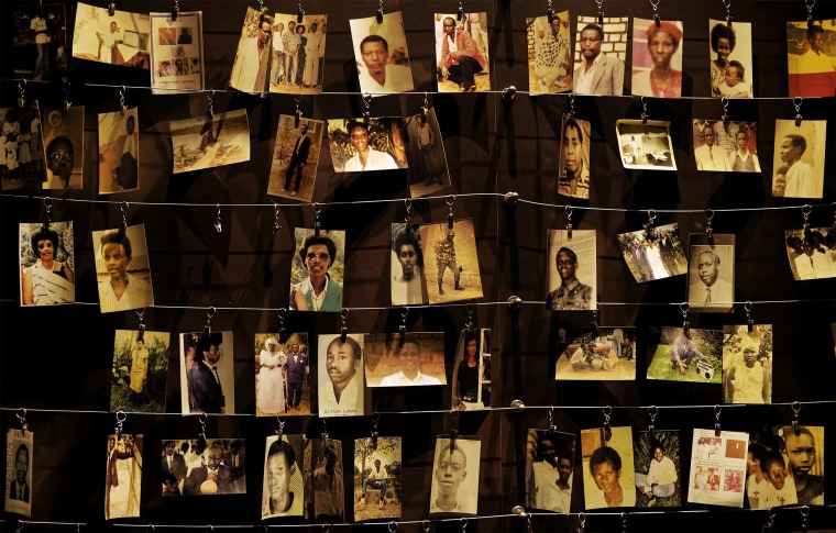 Image: Family photos of some of those who died hang on display in an exhibition at the Kigali Genocide Memorial centre in the Rwandan capital, Kigali