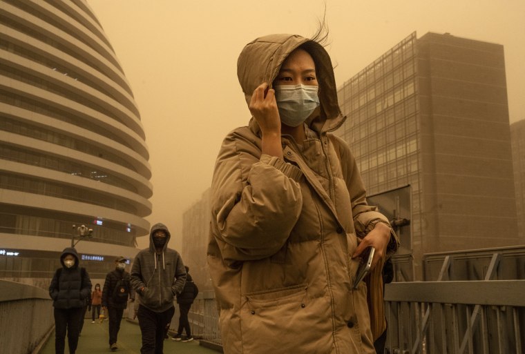 A woman commutes during a sandstorm on March 15, 2021 in Beijing.