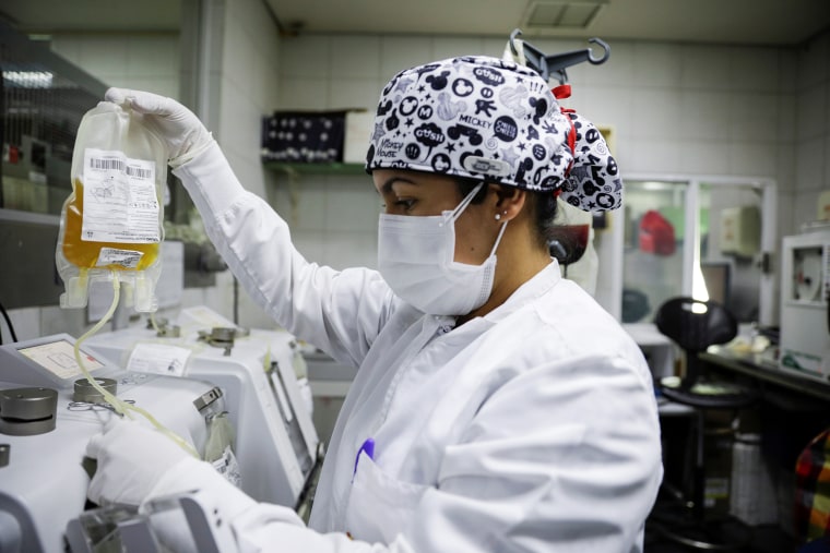 Image: A laboratory technician holds a bag of convalescent plasma, donated by a patient who recovered from Covid-19, at a blood bank in Toluca
