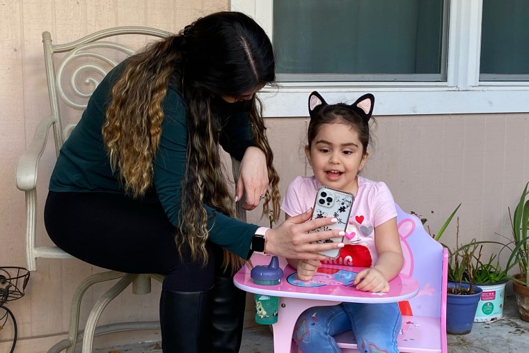 Image: Safieh Mohammadi, who lives in Houston, and her daughter, Lili, video chat Bahram, who is currently in Canada.