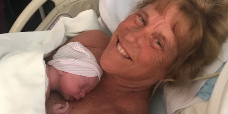 Higgins poses with baby Jack after giving birth at age 57.