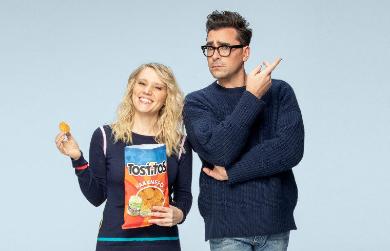 Dan Levy and Kate McKinnon appear in an ad for Tostitos chips.