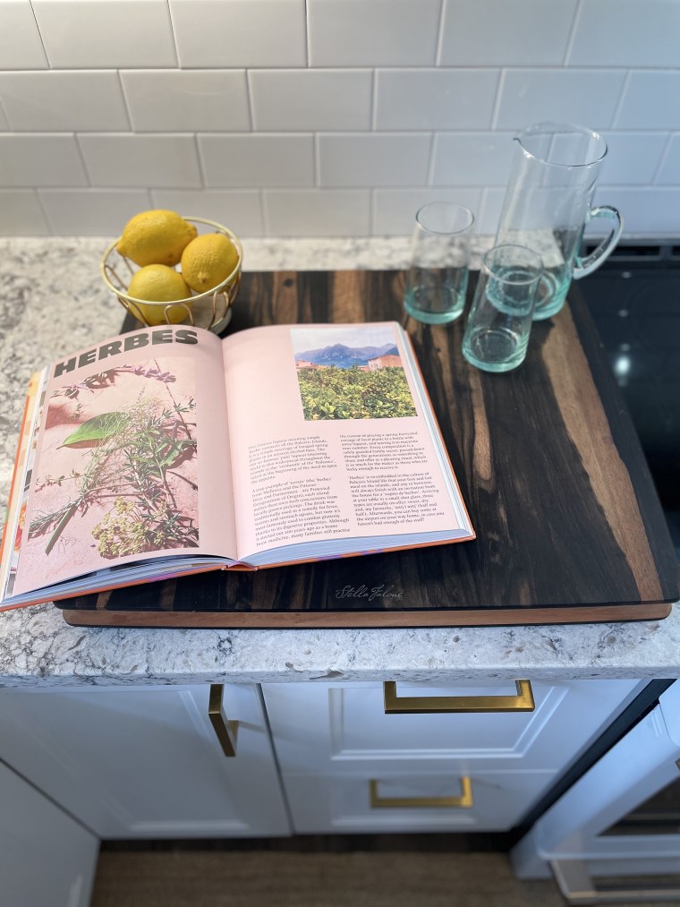 An ebony cutting board made from leftover Taylor guitar parts, a cookbook I found on a memorable day in Brooklyn and handmade Moroccan glassware from Revival helped create warm, personal touches in a clean, modern kitchen.