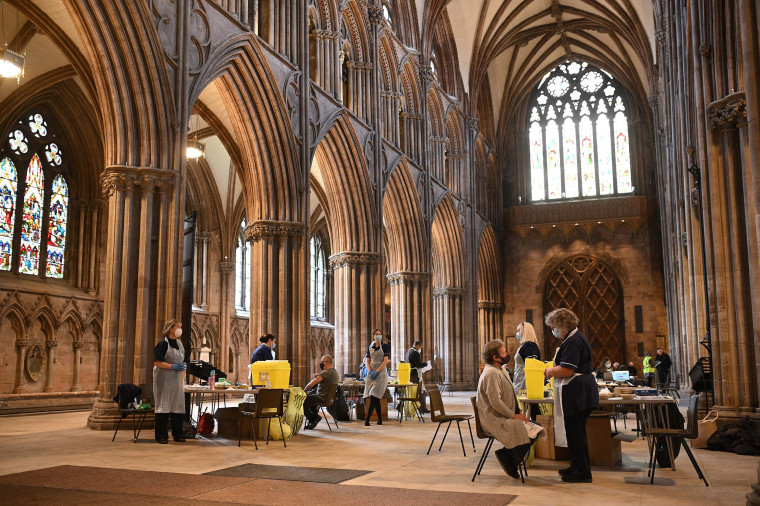 Image: Members of the public receive a dose of the AstraZeneca/Oxford Covid-19 vaccine at Lichfield cathedral, which has been converted into a temporary vaccination center,  central Englan