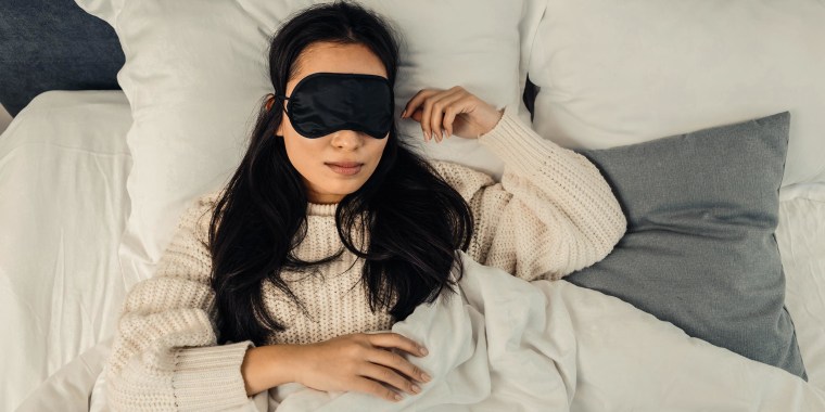 Woman sleeping, wearing a black face mask. Need help falling asleep? Shop the best sleep products of 2021 to help get some rest and relieve stress, from a mattress upgrade, a weighted blanket and more.