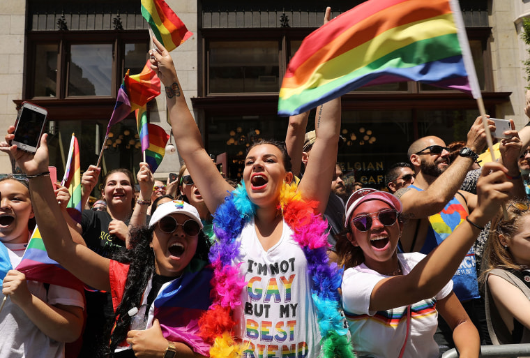 Image: People cheer for marchers walking down 5th Avenue in the annual New York Gay Pride Parade
