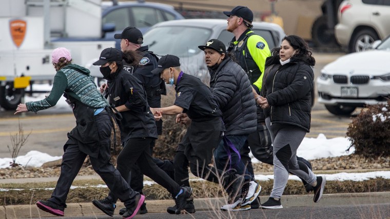 Image: Shoppers are evacuated from a King Soopers grocery store after a gunman opened fire on March 22, 2021 in Boulder, Colo.