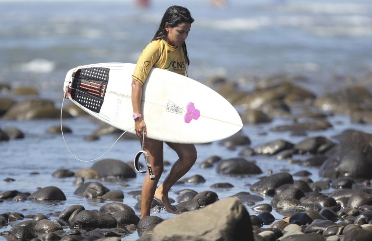 Image: Salvadoran surfer Katherine Diaz walks during the National Surf Circuit at the beaches of El Tunco