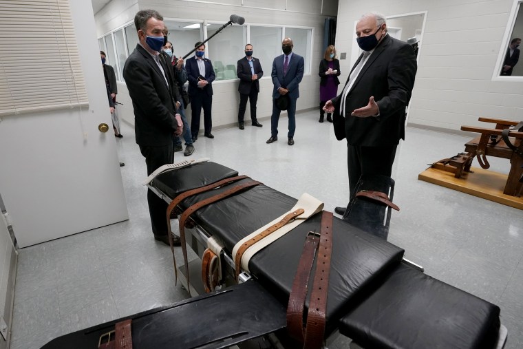IMage: Virginia Gov. Ralph Northam looks at a gurney at Greensville Correctional Center with Operations Director George Hinkle on March 24, 2021.