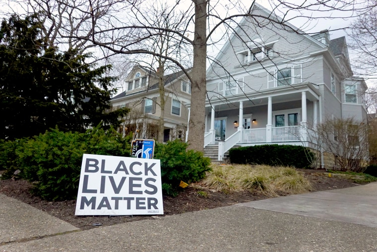 Image: A Black Lives Matter sign sits in front of a home on March 23, 2021 in Evanston, Ill.