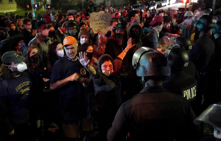 Image: Demonstrators face off with police in the Echo Park section of Los Angeles on March 25, 2021.