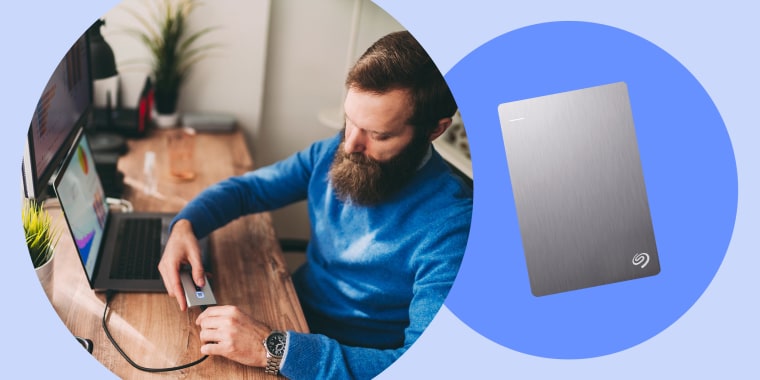 Illustration of a man at his home office plugging in a hard drive to his laptop and a seagate plus slim hard drive in silver. Shop the best hard drives and accessories, according to a Shopping writer.