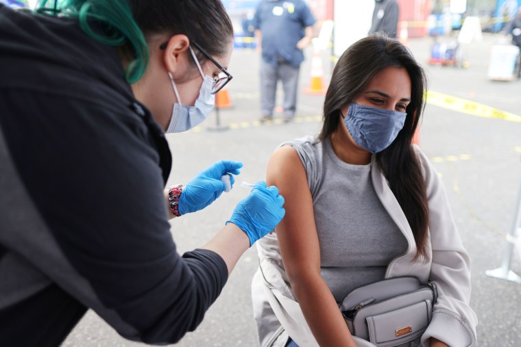 Esperanza Guevara, 31, receives a Johnson & Johnson vaccination, in Los Angeles, Calif. on March 25, 2021.