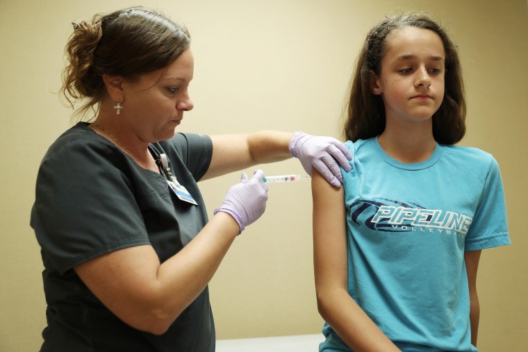 Nurse Laura Johnson administers a dose of the human papillomavirus (HPV) vaccine to Abby Major, 13 in Hoffman Estates, Ill.