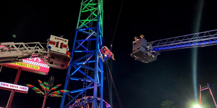 Image: Two teens being rescued from 'Slingshot' ride in Kissimmee, Fla.