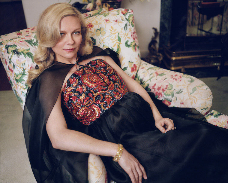 Kirsten Dunst in a Chanel cape and dress