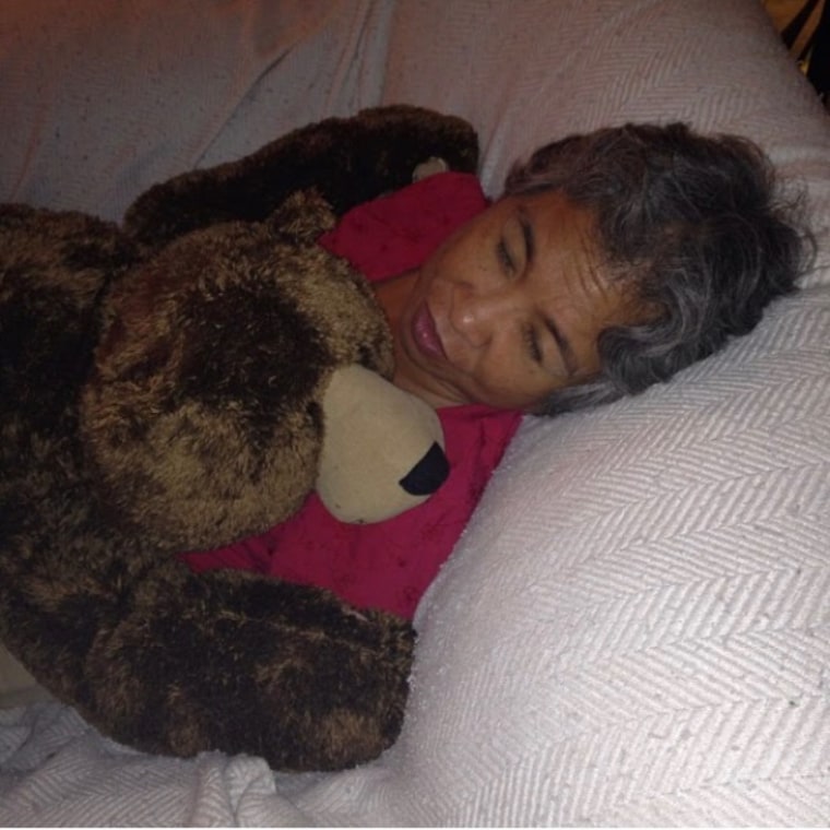 Tina Rhodes' mom cuddling a cherished stuffed bear.