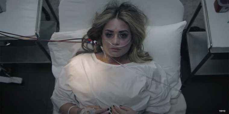Demi Lovato revisits her 2018 near-fatal overdose in the music video for her latest single, “Dancing With the Devil.”