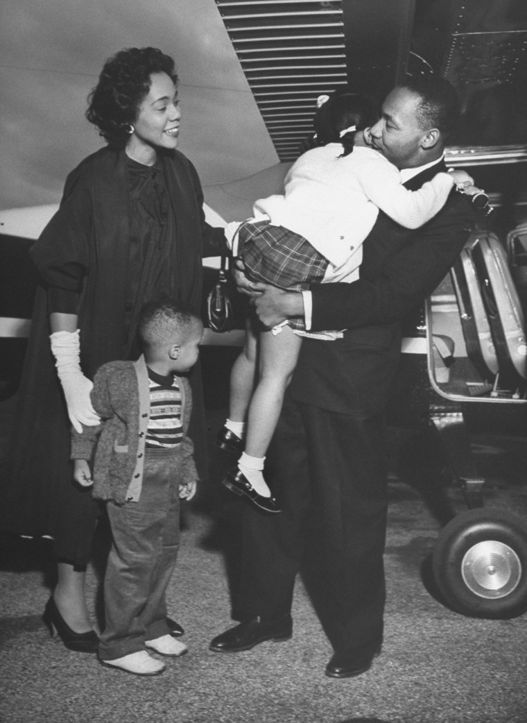 Civil rights leader Martin Luther King Jr. hugs his daughter Bernice as his wife, Coretta, and son Martin III joyfully look on as they greet him at airport upon his release from prison after incarceration for leading boycotts.