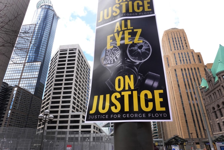Image: Posters hang outside of the Hennepin County Government Center during a rally being held before the trial of former Minneapolis police officer Derek Chauvin