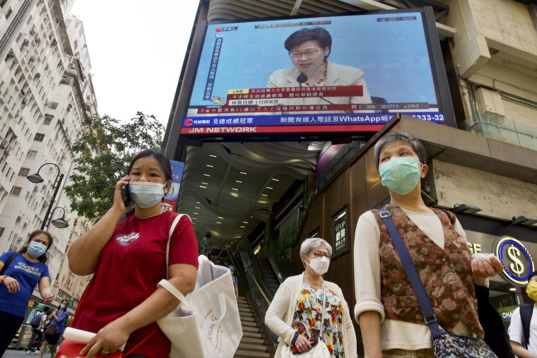 Image: A TV screen broadcasts Hong Kong Chief Executive Carrie Lam during a news conference in Hong Kong,