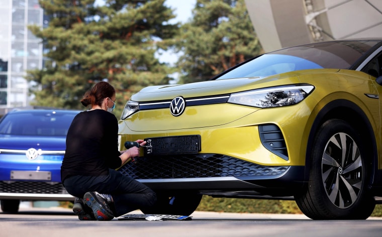 An employee prepares a new Volkswagen ID.4 SUV electric automobile for delivery  in Wolfsburg, Germany, on March 26, 2021.