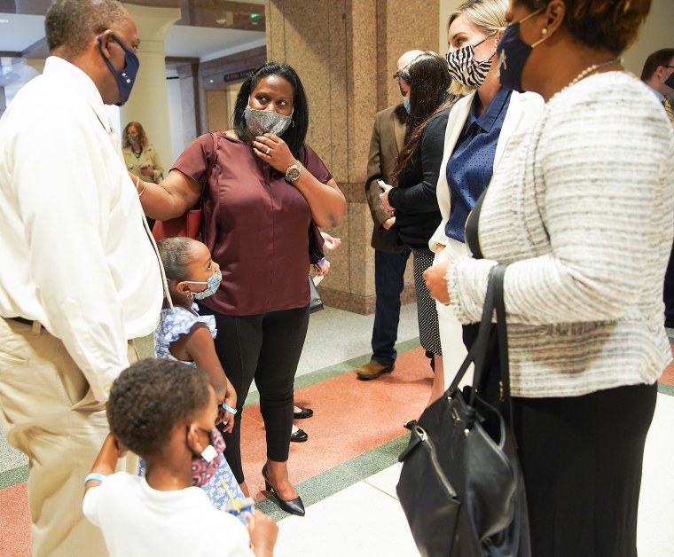 Image: Sharde Butler with her husband, Lance, before a hearing  in Austin on March 30, 2021.