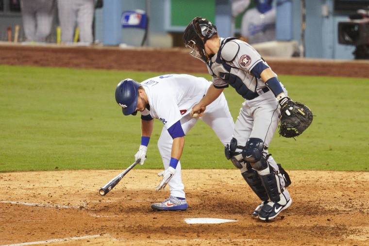 Houston Astros catcher Dustin Garneau tags Los Angeles Dodgers designated hitter Gavin Lux after he struck out to end a MLB game on Sept. 12, 2020, at Dodger Stadium in Los Angeles.