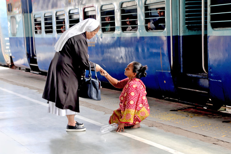 Sister Rose Paite consoles a woman in the Guwahati Railway Station in Assam, India.