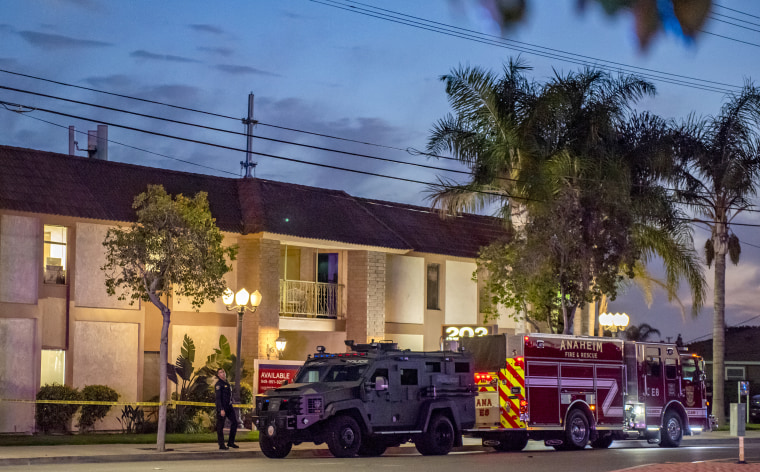 A SWAT vehicle and fire engine park outside 202 West Lincoln Avenue as police investigate a shooting with multiple victims in Orange, Calif., on March 31, 2021.