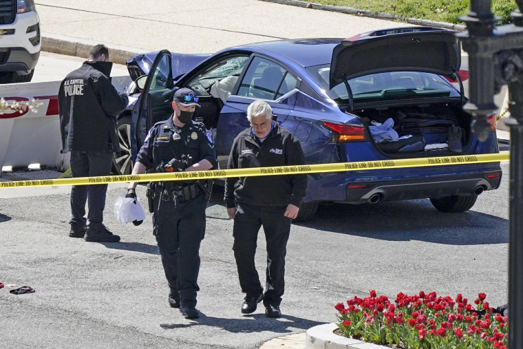 Image: Capitol Police officers near a car that crashed into a barrier on Capitol Hill on April 2, 2021.