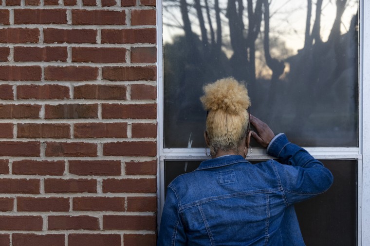 Image: Rosa Jackson looks though a window into her old apartment in Horn Lake, Miss., on April 1, 2021.