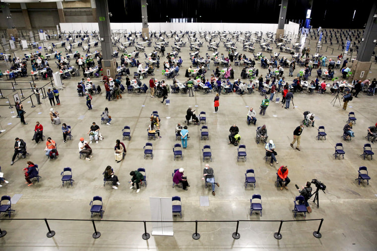 Image: Patients sit in an observation area after receiving the Pfizer Covid-19 vaccine during opening day of the Community Vaccination Site at the Lumen Field Event Center in Seattle on on March 13, 2021